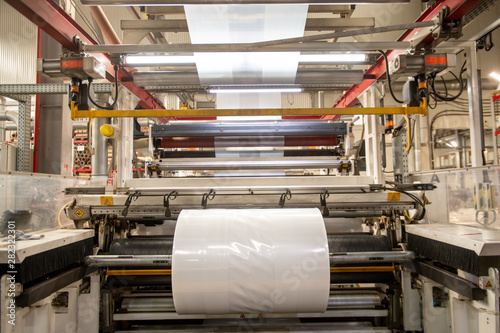 Huge industrial machine with rolled newly produced transparent polyethylene film
