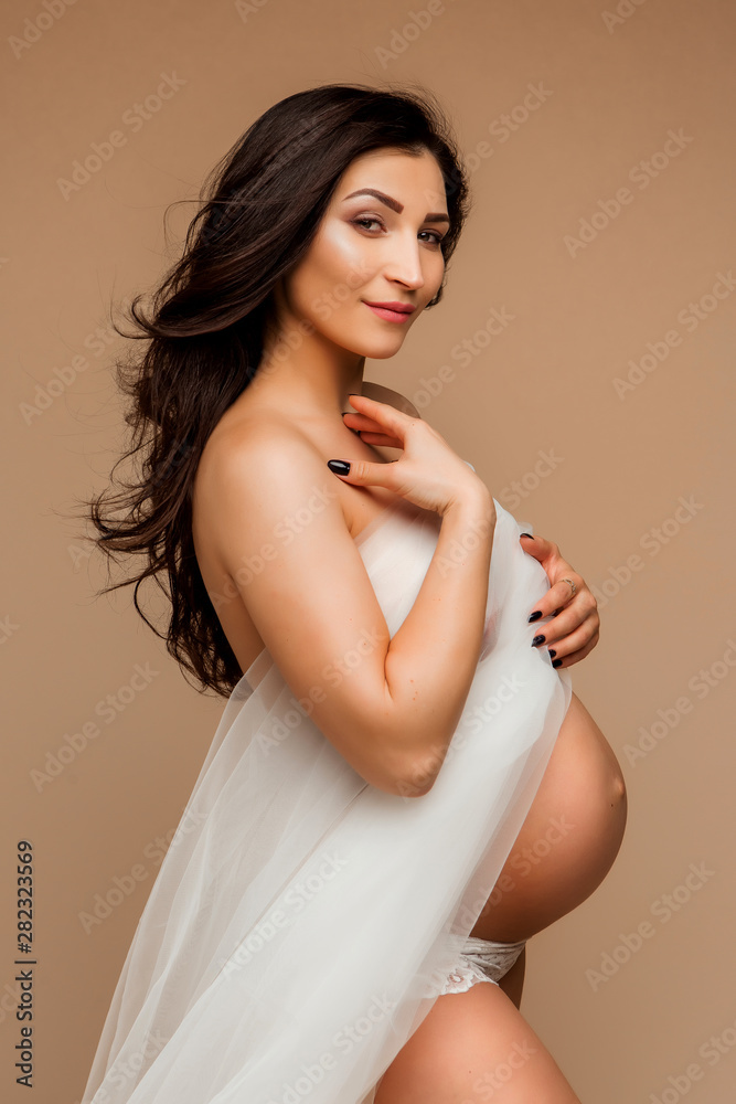 Fototapeta premium pregnant woman on light background