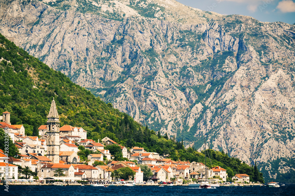 Classic  view of the historic town of Perast located at world-famous Bay of Kotor on a beautiful sunny day with blue sky and mountains  in summer, Montenegro, southern Europe.