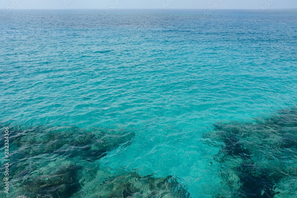 Fototapeta premium the coast with transparent water through which stones at the bottom are visible