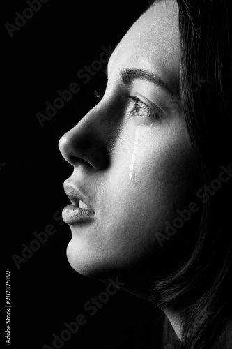 Billede på lærred Profile of young woman crying, black and  white