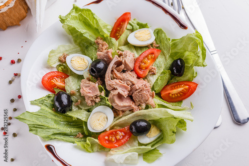 Fresh salad with iceberg lettuce,tomatoes,eggs,canned tuna and olives