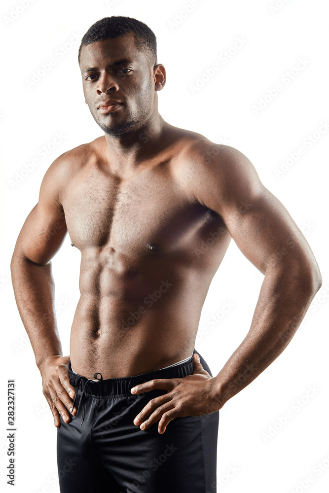 strong afro-american handsome guy showing off his physique against white background.close up portrait. isolated white background. studio shot. strong afro-american handsome guy showing off his physique against white background.close up portrait. isolated white background. studio shot.