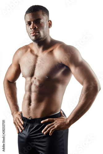 strong afro-american handsome guy showing off his physique against white background.close up portrait. isolated white background. studio shot.