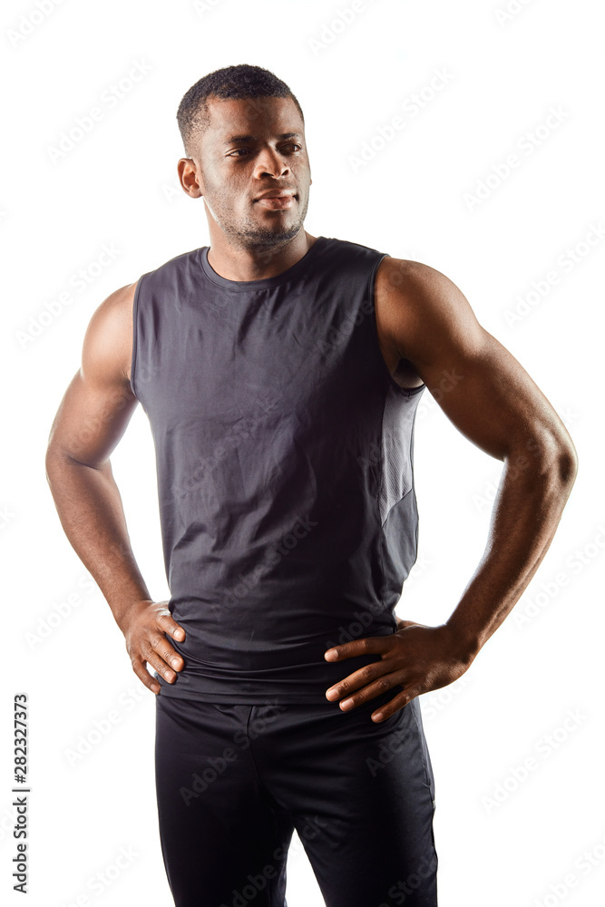 confident handsome young african man standing with hands on the hips , looking away against white background. close up portrait. free time, spare time, man has a rest after workout. fashion confident handsome young african man standing with hands on the hips , looking away against white background. close up portrait. free time, spare time, man has a rest after workout. fashion