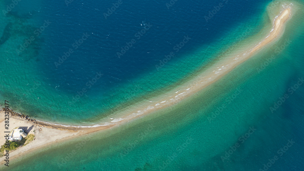Aerial drone photo of tropical exotic island sand bar separating sea in two with turquoise and sapphire breathtaking colours