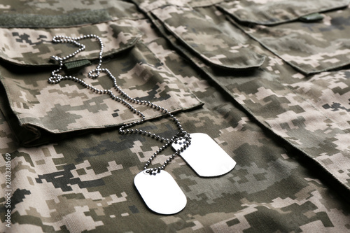 Military ID tags with chain on camouflage uniform photo