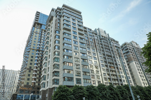 KYIV, UKRAINE - MAY 21, 2019: Beautiful view of modern housing estate in Pecherskyi district on sunny day, low angle photo