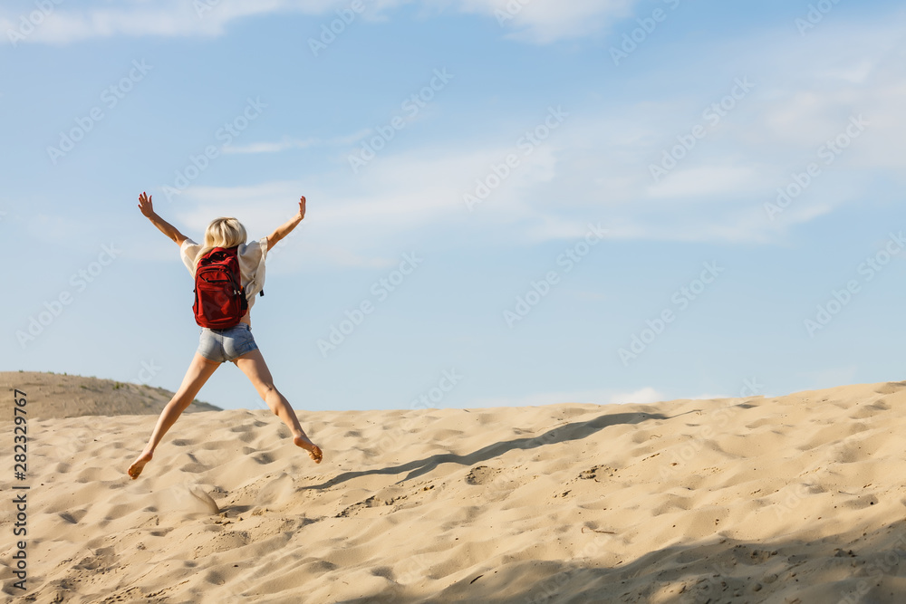 Adult woman hiking and backpacking in beautiful desert and rocky landscape Adult woman hiking and backpacking in beautiful desert and rocky landscape
