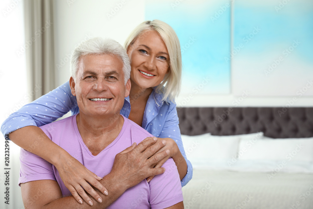 Portrait of happy senior couple at home. Space for text Portrait of happy senior couple at home. Space for text