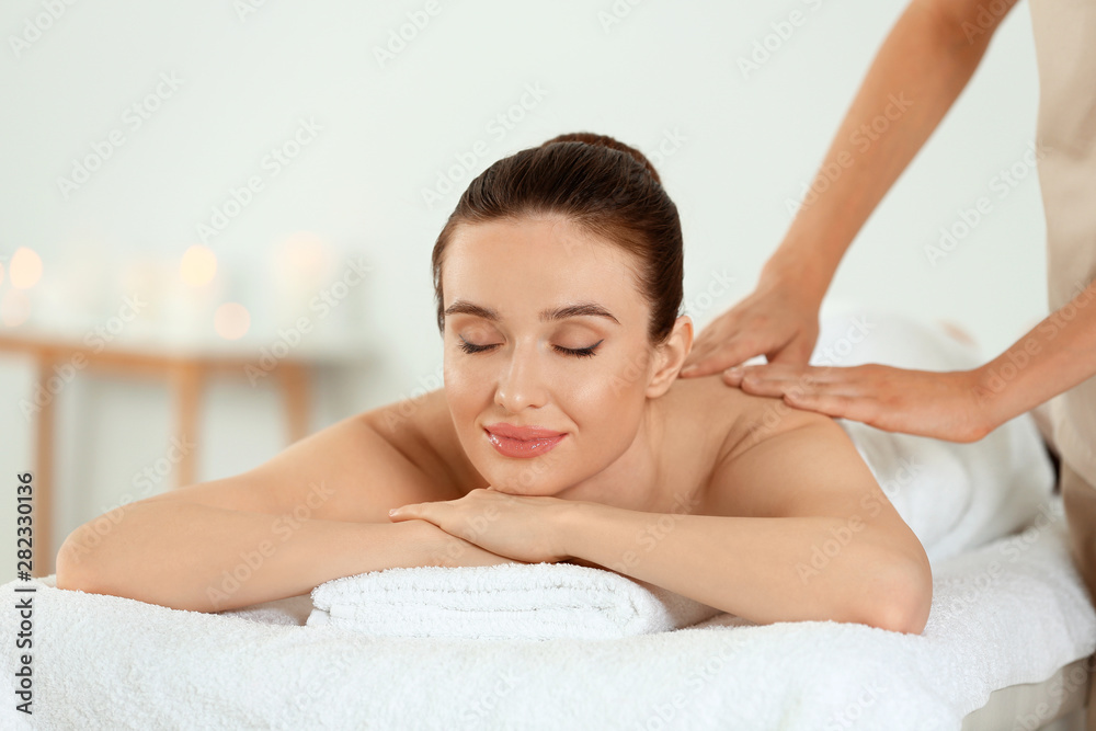 Beautiful young woman enjoying massage in spa salon Beautiful young woman enjoying massage in spa salon