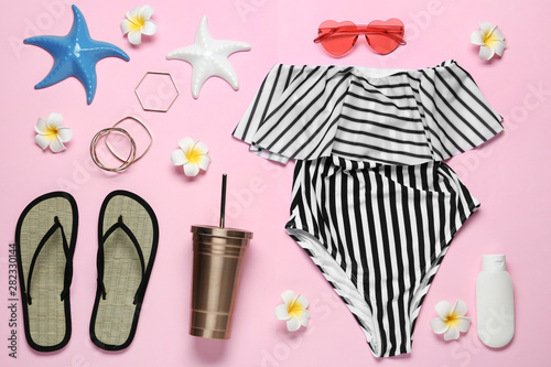 Flat lay composition with women's swimsuit on pink background © New Africa
