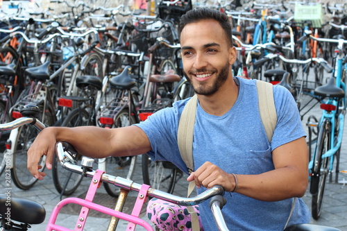 Photography Handsome ethnic man in bicycle parking lot