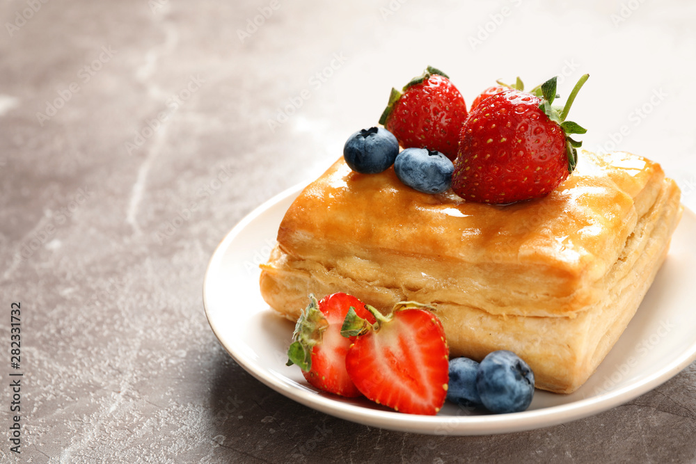 Fresh delicious puff pastry with sweet berries on grey marble table, closeup. Space for text Fresh delicious puff pastry with sweet berries on grey marble table, closeup. Space for text