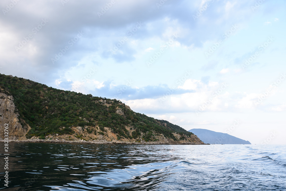 View of the black sea coast in the sunset from the sea. view from ship to shore