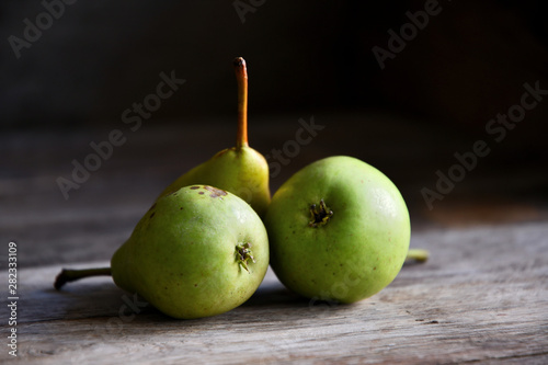 Pears lie on old oak boards.