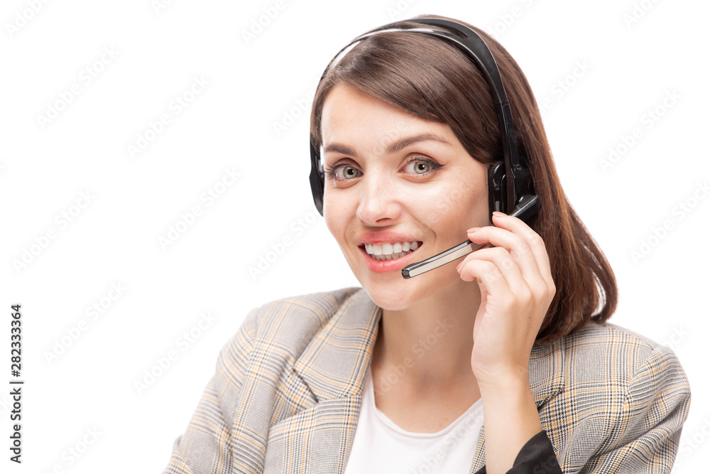 Young smiling hotline consultant in headset answering question of client Young smiling hotline consultant in headset answering question of client