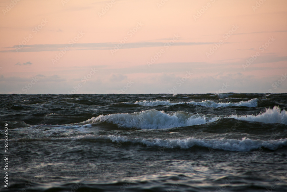 waves with foam at sea in the evening