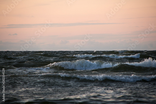 waves with foam at sea in the evening