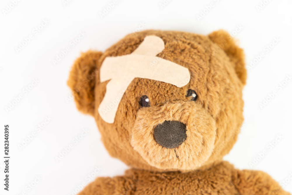 Obraz premium Childhood illness and sick kids concept with a adhesive bandages on its head to cover an injury with copy space