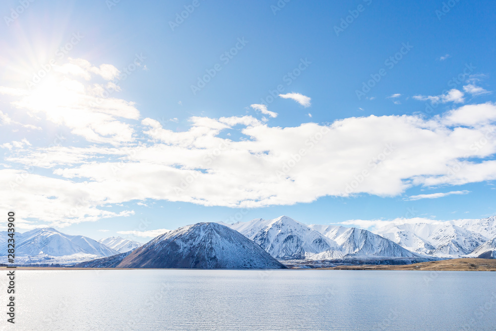 Mountain peaks snow covered mountain range with blue sky and clouds