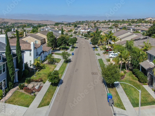 Suburban neighborhood street with big villas next to each other in Black Mountain, San Diego, California, USA. Aerial view of residential modern subdivision luxury house. © Unwind