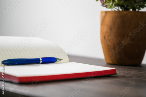 open notebook and pen on wooden table