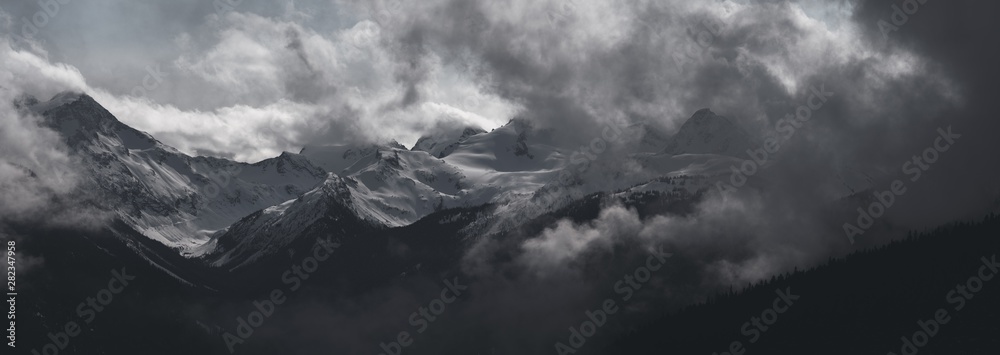 Whistler - Panorama of Dramatic Snow Covered Alpine Peak Surrounded by Storm Clouds - obrazy, fototapety, plakaty 