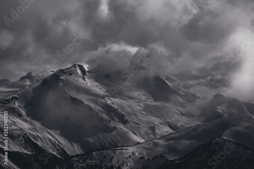 Whistler Blackcomb - Panorama of Dramatic Snow Covered Alpine Peak Surrounded by Storm Clouds