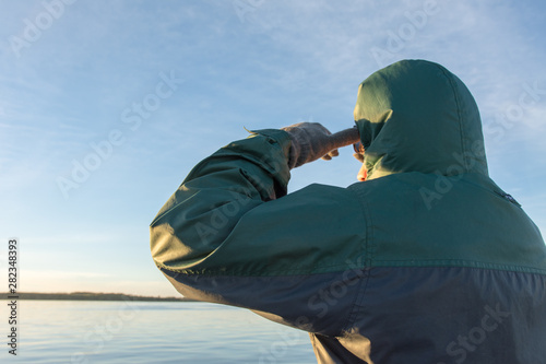 Young Adult Man Outdoors Staring the Horizon with River in Background