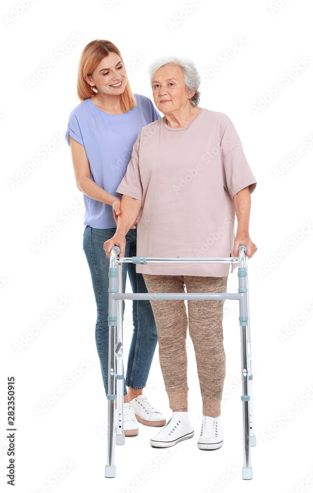 Caretaker helping elderly woman with walking frame on white background Caretaker helping elderly woman with walking frame on white background