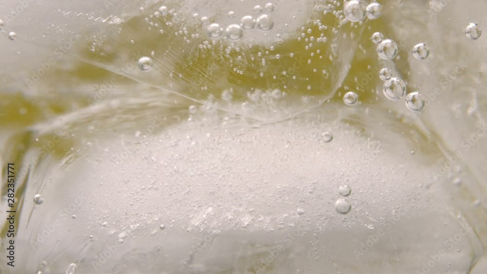 Close-upClose-up of Fizzy drink with ice cubes. Bubbles and water drops on glass. Food background of Fizzy drink with ice cubes. Bubbles and water drops on glass. Food background. 4K UHD video footage Close-upClose-up of Fizzy drink with ice cubes. Bubbles and water drops on glass. Food background of Fizzy drink with ice cubes. Bubbles and water drops on glass. Food background. 4K UHD video footage