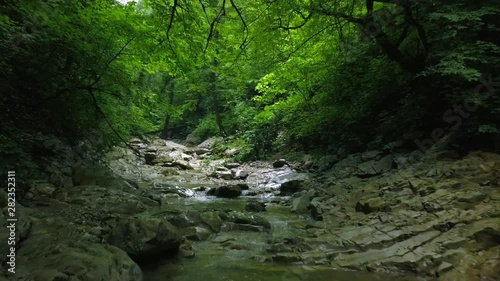 Flying over a mountain river Beautiful views of the water in the mountain canyon