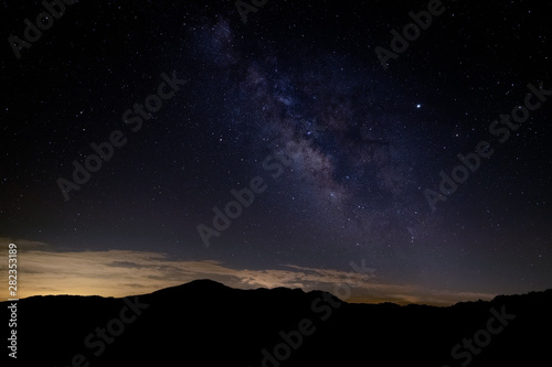 Fotografie Milky Way Galaxy arm seen over Grandfather Mountain in North Carolina at night