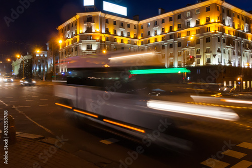 Motion blurred minibus on the avenue in the evening.