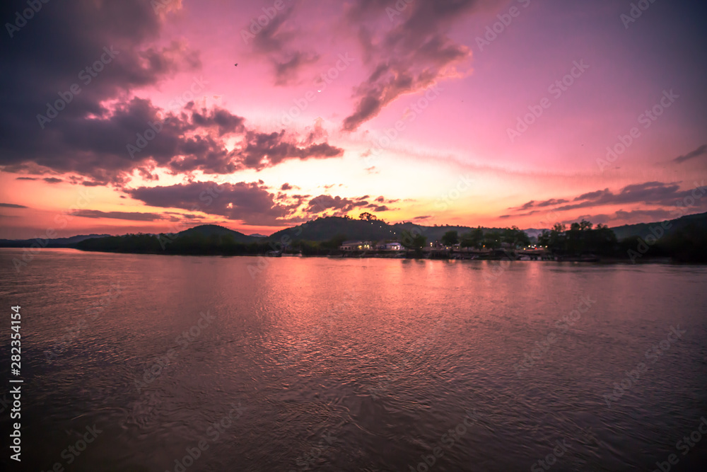 Fototapeta premium The natural background of the sky is blurred from the twilight light in the evening. There are a variety of colors, trees (mangroves, rivers, waterfront communities), complementary living