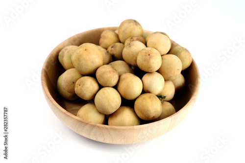 LongKong is placed on a wooden tray. Tropical fruit, Langsat, lanzones, Lansium parasiticum on a white background. - Image