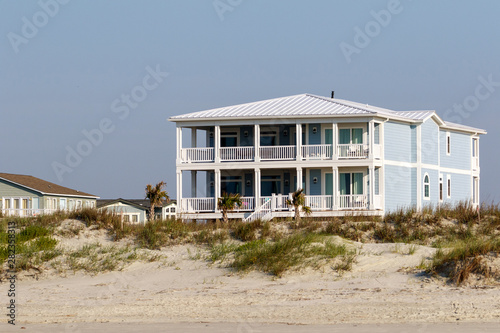  Luxury beach vacation houses across the green sand dunes, in Sunset Beach, North Carolina. 