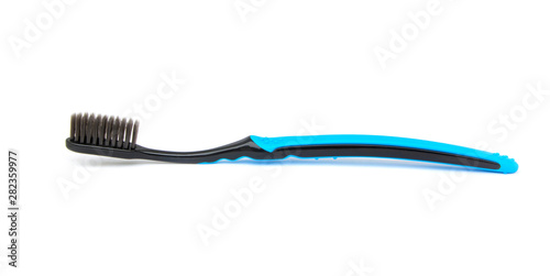 Blue toothbrush Slender black bristles charcoal Isolated on white background.