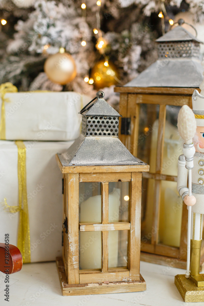 Christmas lanterns indoor. Vintage New Year decorations. Wooden gift boxes  and lantern under fir-tree. Christmas mood. Celebrating of New Year Stock  Photo | Adobe Stock