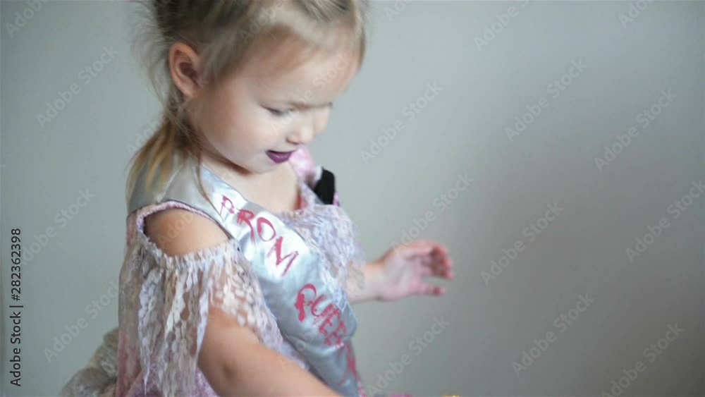 Happy Little Girl In A Halloween Costume Is Taking a Candles. She Looks So Cutie and Funny. Halloween Concept. Happy Little Girl In A Halloween Costume Is Taking a Candles. She Looks So Cutie and Funny. Halloween Concept.