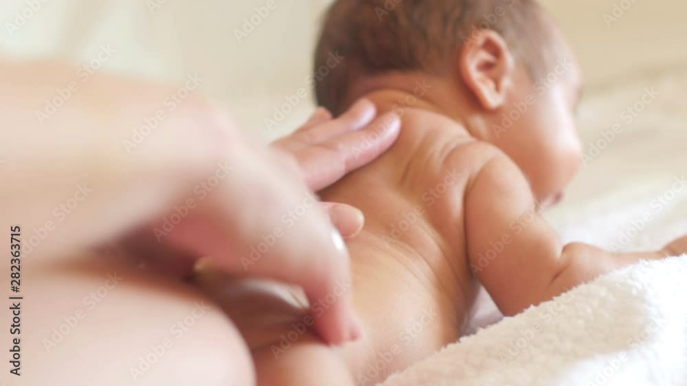 Mom does massage using oil to the baby. Caring for the newborn. Mom does massage using oil to the baby. Caring for the newborn.