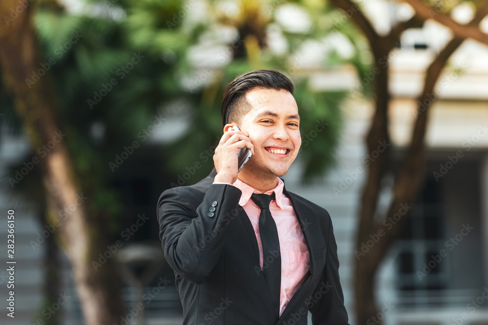 Young Malay Business Man talking on his Smartphone. Young Malay Business Man talking on his Smartphone.