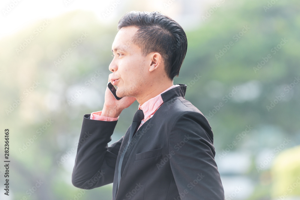 Young Malay Business Man talking on his Smartphone. Young Malay Business Man talking on his Smartphone.