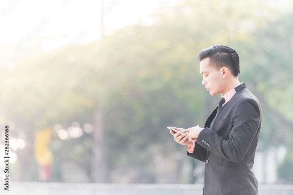 Young Malay Business Man on his Smartphone. Copy space on left. Young Malay Business Man on his Smartphone. Copy space on left.