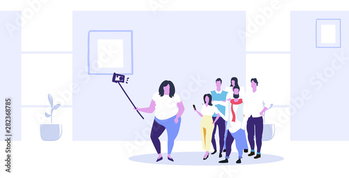 fat obese woman holding selfie stick businesswoman with casual colleagues group taking photo on smartphone camera coworkers team standing together modern office interior sketch full length horizontal