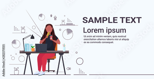 fat obese businesswoman eating sandwich drinking cola overweight african american girl sitting at workplace desk with laptop unhealthy nutrition obesity concept full length horizontal copy space