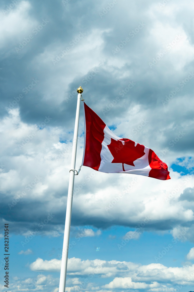 Canadian Maple Leaf national Flag flying over mountains Canadian Maple Leaf national Flag flying over mountains