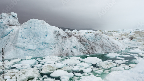 Climate Change and Global Warming - Icebergs from melting glacier in icefjord in Ilulissat, Greenland. Image of arctic nature ice landscape. Unesco World Heritage Site.