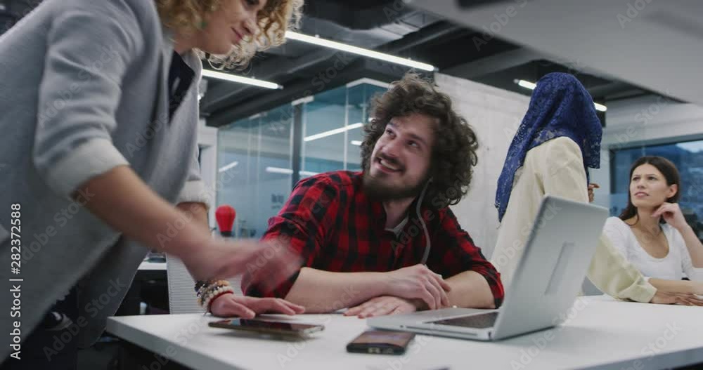 Young multiethnic business team of software developers working together using
